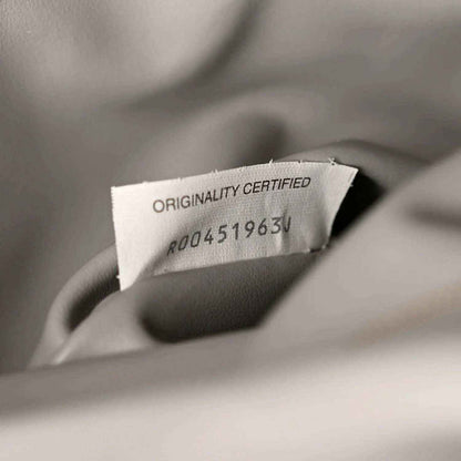 Suede authenticity tag reading Originality Certified with code