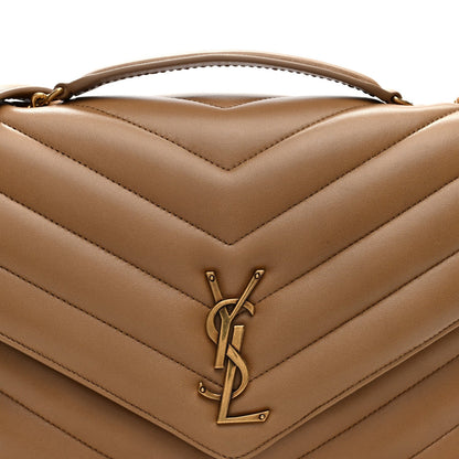 Chevron quilted flap detail with gold-tone YSL clasp on natural tan leather