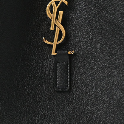 Black leather hobo bag with gold YSL monogram on a hanging leather tab