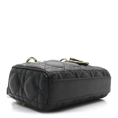 Black quilted mini handbag with rounded top and gold-tone hardware loops