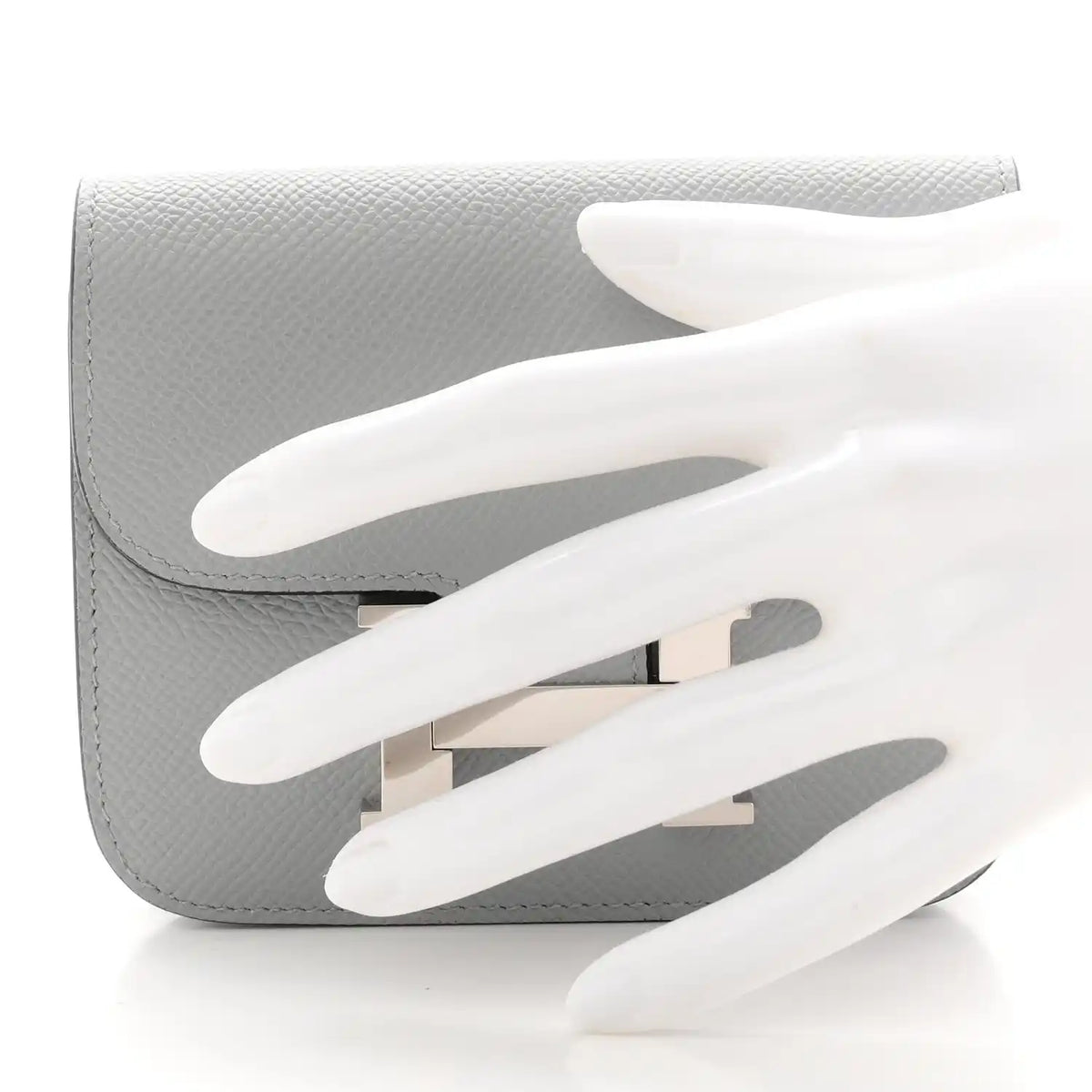 Hermes Constance slim wallet, light blue textured leather, open flap with H clasp.