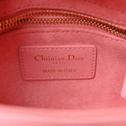 Light pink handbag interior label reading Christian Dior and Made in Italy