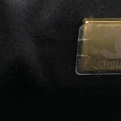 Transparent tag on black leather handbag fabric