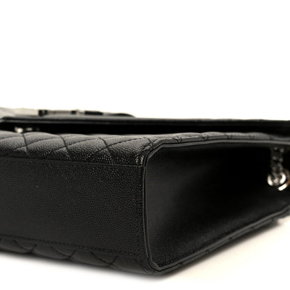 Black quilted leather satchel with structured corner and zipper trim