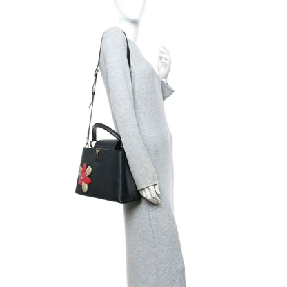 Louis Vuitton Capucines BB bag in black leather with flower applique and shoulder strap