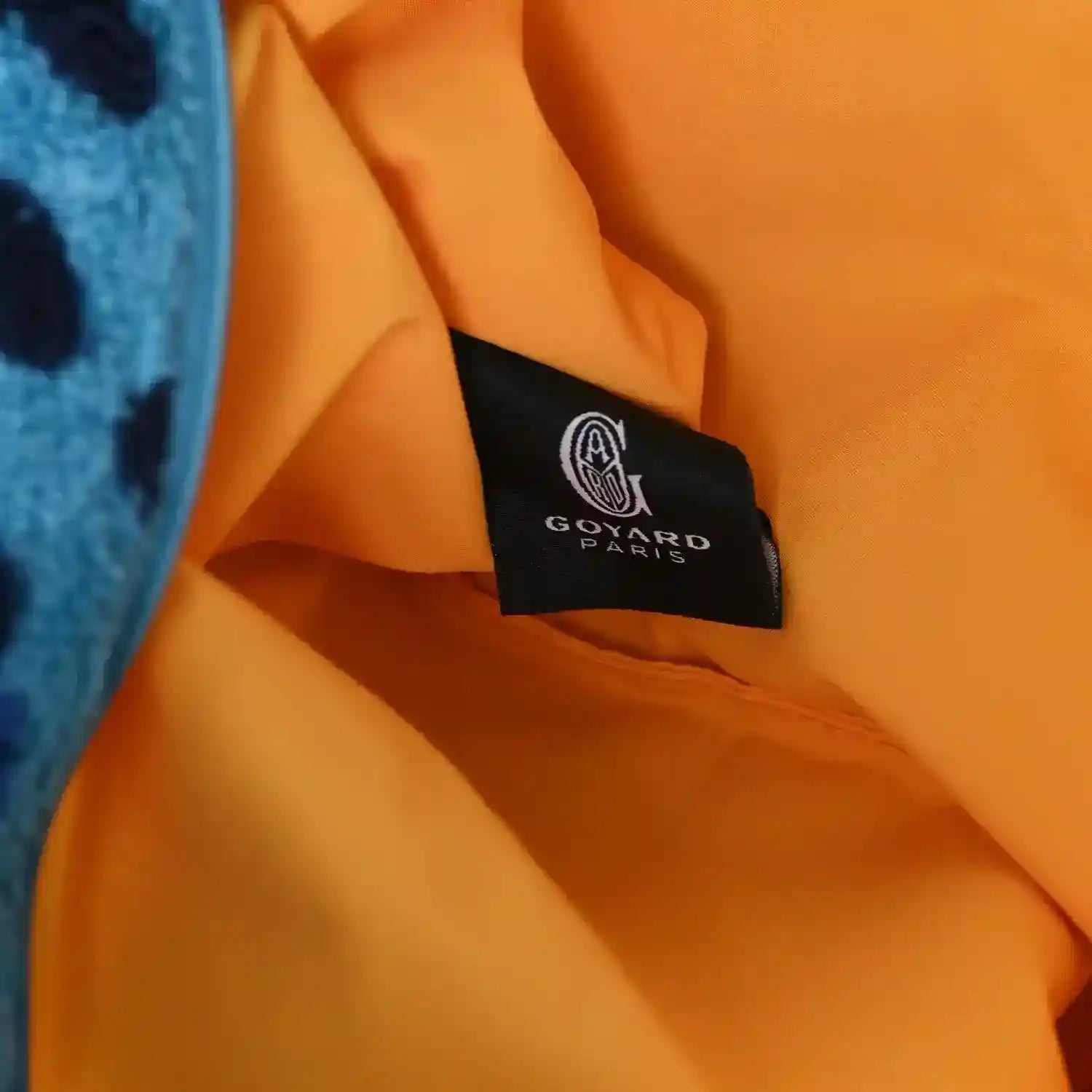 Cotton tote interior with orange lining and black Goyard Paris label patch.