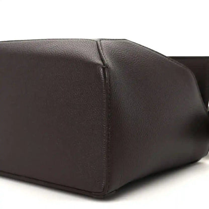 Dark chestnut grained leather small bag bottom corner with smooth panel and stitching