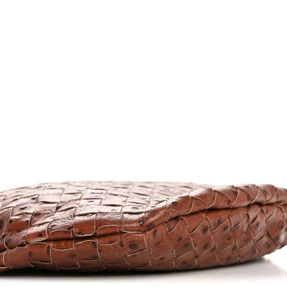 Light brown embossed leather base with braided edge and metal eyelet.