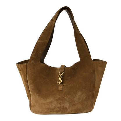 Suede tote bag with YSL charm at center, golden-brown suede