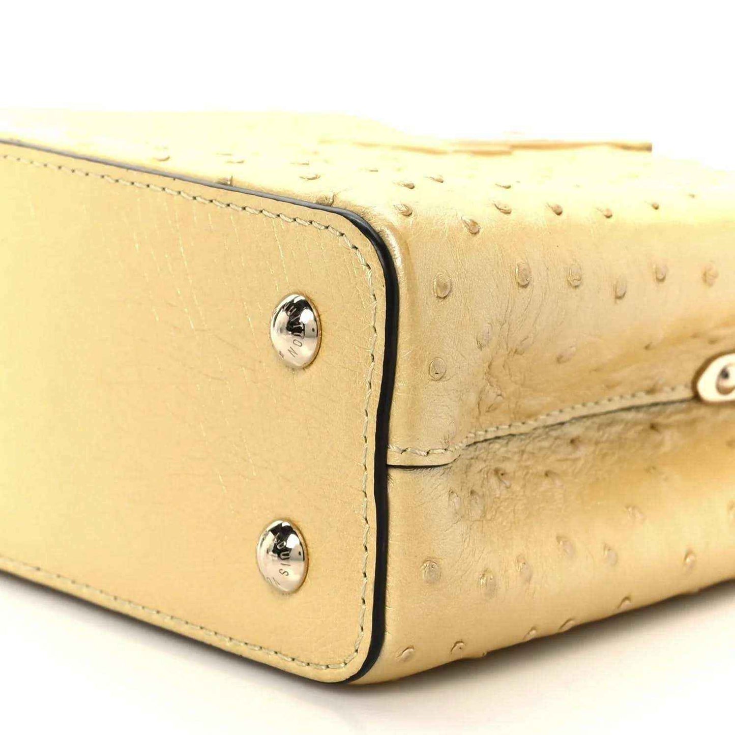 Yellow mini bag side panel with two silver snaps and stitched edging