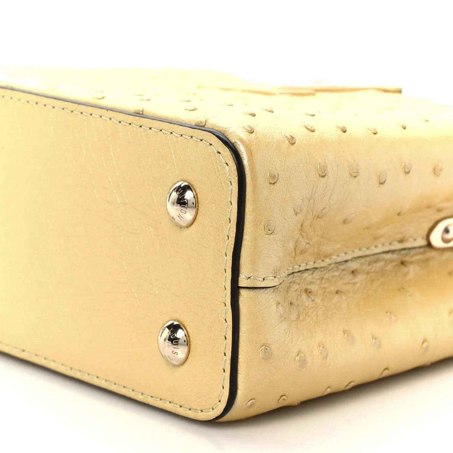 Yellow mini bag side panel with two silver snaps and stitched edging