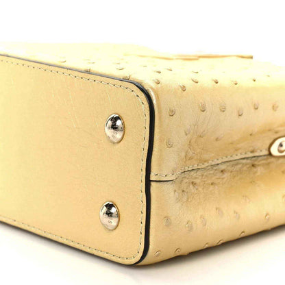 Yellow mini bag side panel with two silver snaps and stitched edging