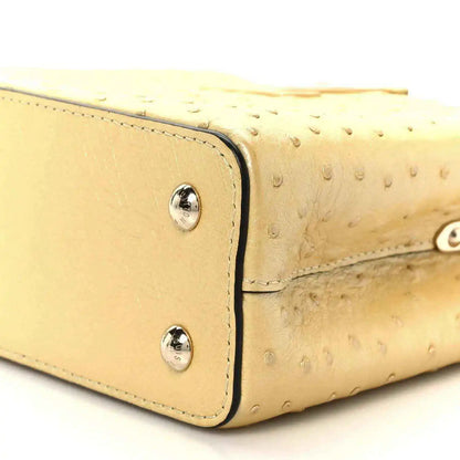 Yellow mini bag side panel with two silver snaps and stitched edging