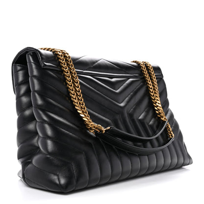 Black quilted calfskin satchel with gold chain strap and curved flap