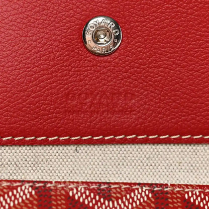 Red Goyardine bag exterior with round silver snap stud