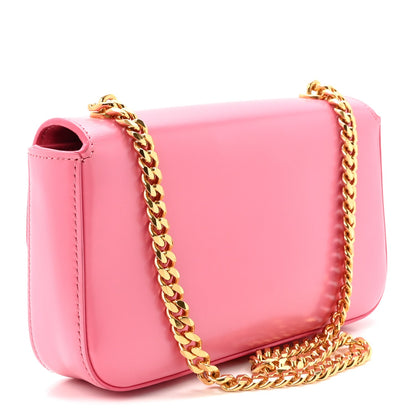 Flamingo pink leather shoulder bag with gold chain and side opening detail
