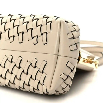 Ivory woven leather clutch with gold-tone hardware and shoulder strap attachment