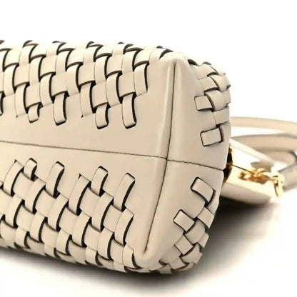 Ivory woven leather clutch with gold-tone hardware and shoulder strap attachment