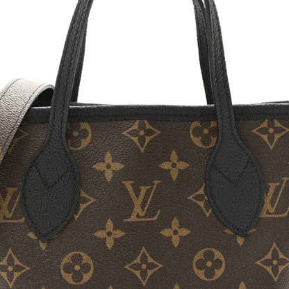 Monogram tote bag front close-up with black handles and brown patterned canvas and leather inserts