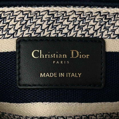 Blue toile de Jouy handbag interior brand label reading “Christian Dior” and “Made in Italy”.