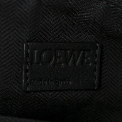 Black leather brand label on small raffia puzzle bag interior