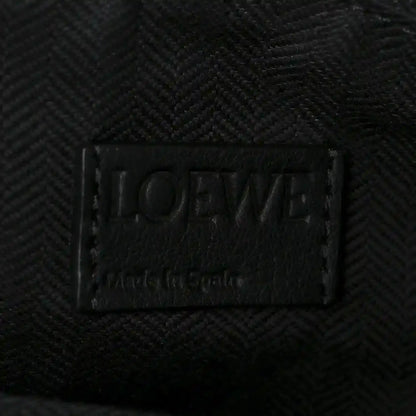 Black leather brand label on small raffia puzzle bag interior