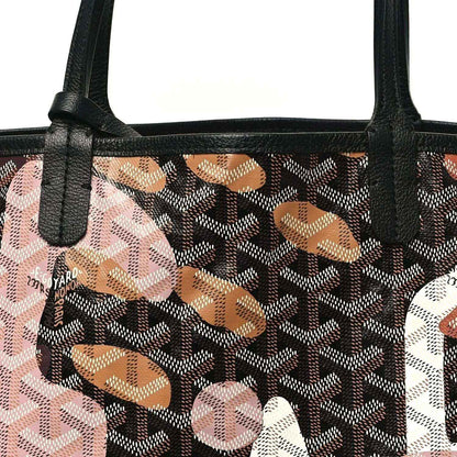 PM tote bag close-up: black handle base on dark monogram canvas with pink and orange graphics