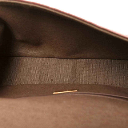 Dark interior lining of a baguette bag with zipper track at the top opening