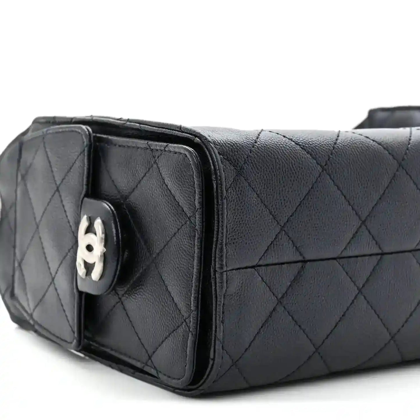 Quilted mini handbag side view with flap closure and silver-tone hardware