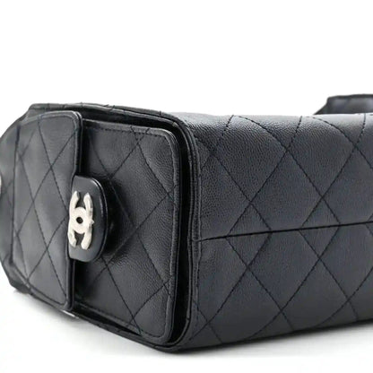 Quilted mini handbag side view with flap closure and silver-tone hardware