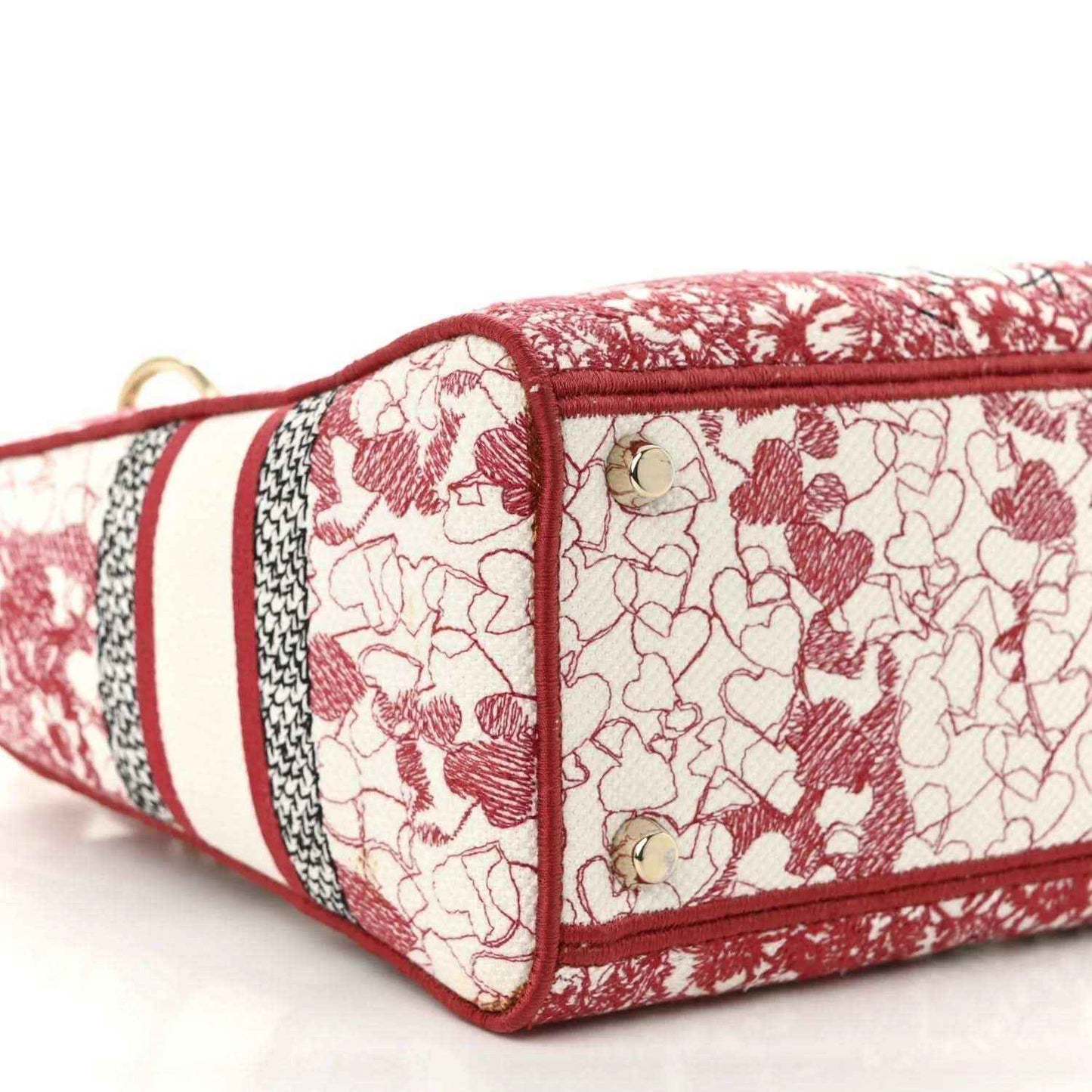 Medium canvas bag with red-and-white heart pattern, red base edge and side panel.