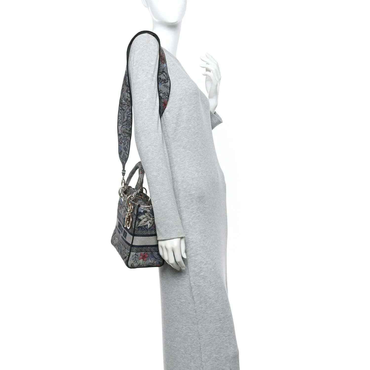 Christian Dior embroidered denim bag worn crossbody with shoulder strap