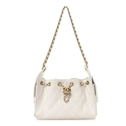 White quilted mini handbag with gold chain strap and front clasp detail