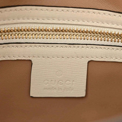 Leather interior label with gold zipper teeth and stitched seam detail.