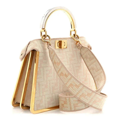 Fendi small Peekaboo satchel bag open with light beige FF pattern, gold clasp, and wrist strap