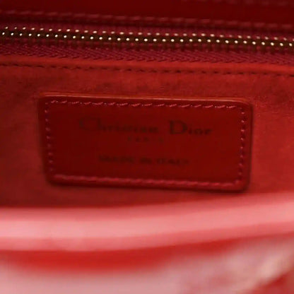 Christian Dior small red patent quilted handbag, close-up of brand label on inner pocket