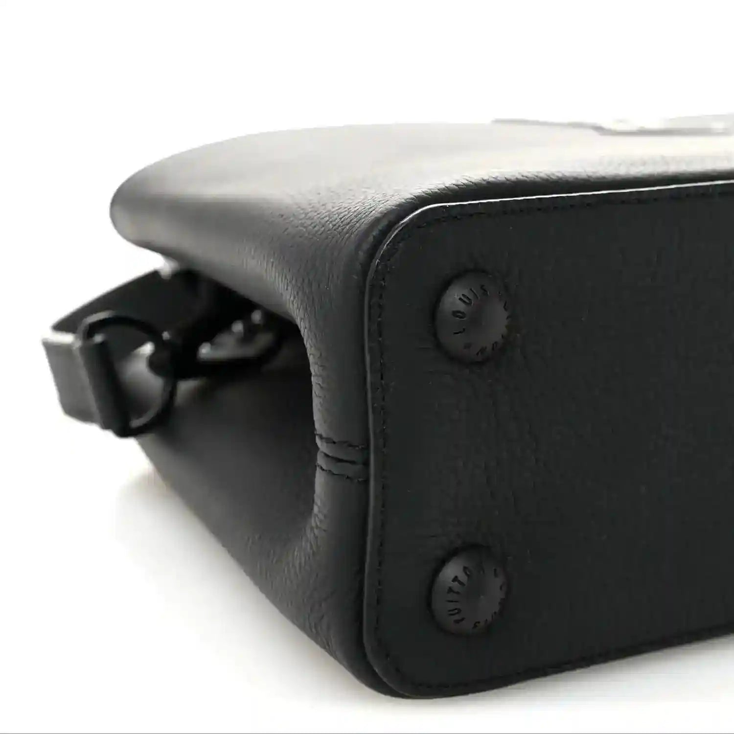 Matte black leather handbag corner with strap attachment hardware