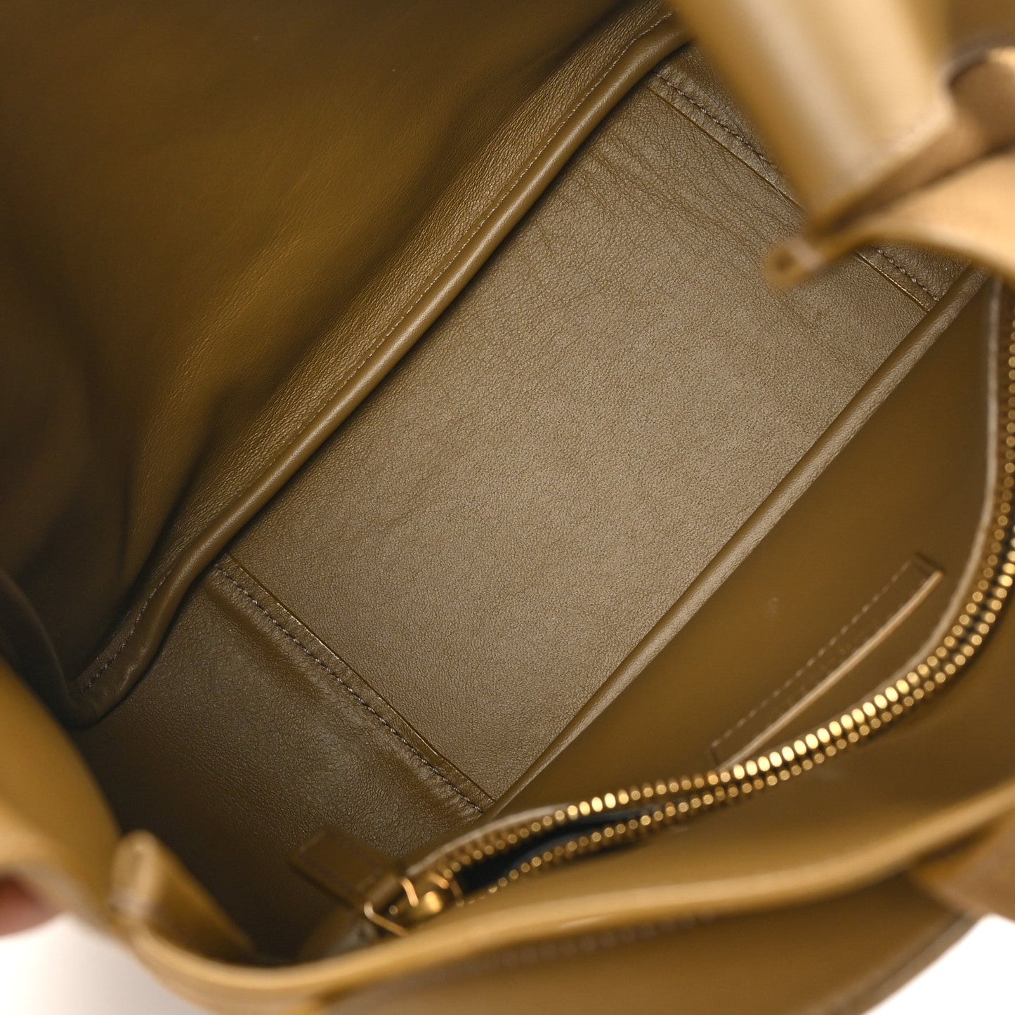 Small hobo bag interior detail with zipper track and smooth suede-like lining