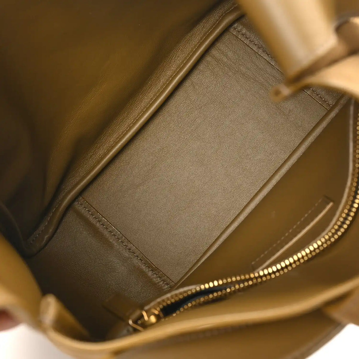 Small hobo bag interior detail with zipper track and smooth suede-like lining