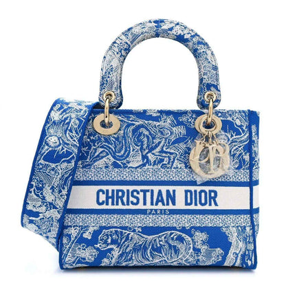 Dior tote bag in bright blue Toile de Jouy print with top handles and logo strip