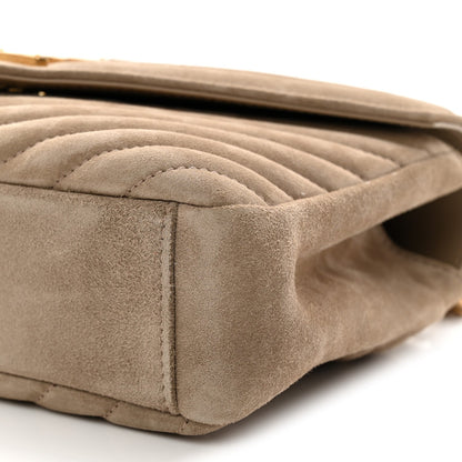 Taupe suede quilted side panel close-up with stitched edge
