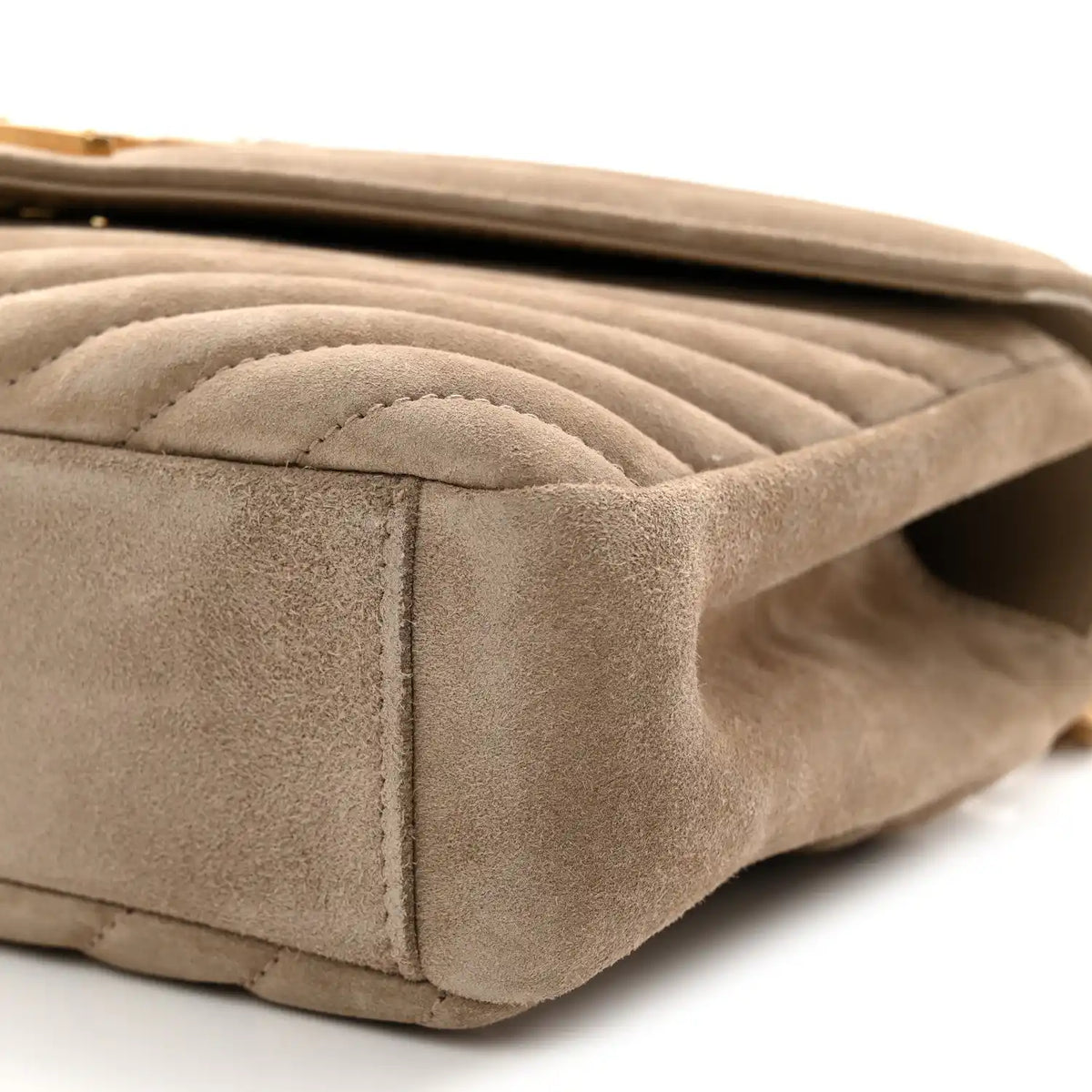Taupe suede quilted side panel close-up with stitched edge
