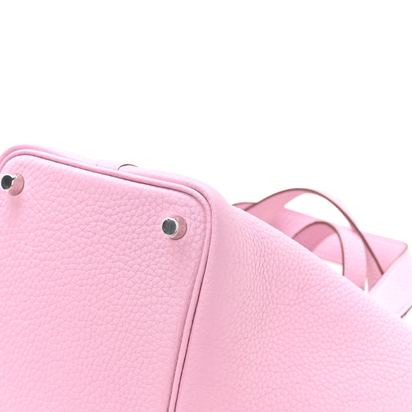 Rose pink textured leather handbag corner with metal stud and short handles