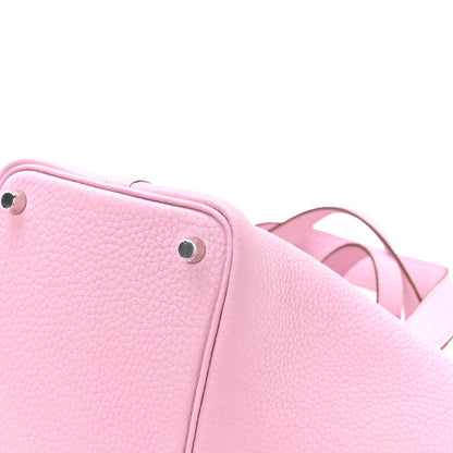 Rose pink textured leather handbag corner with metal stud and short handles