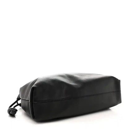Black leather flamenco bag back panel with curved seam and strap loops