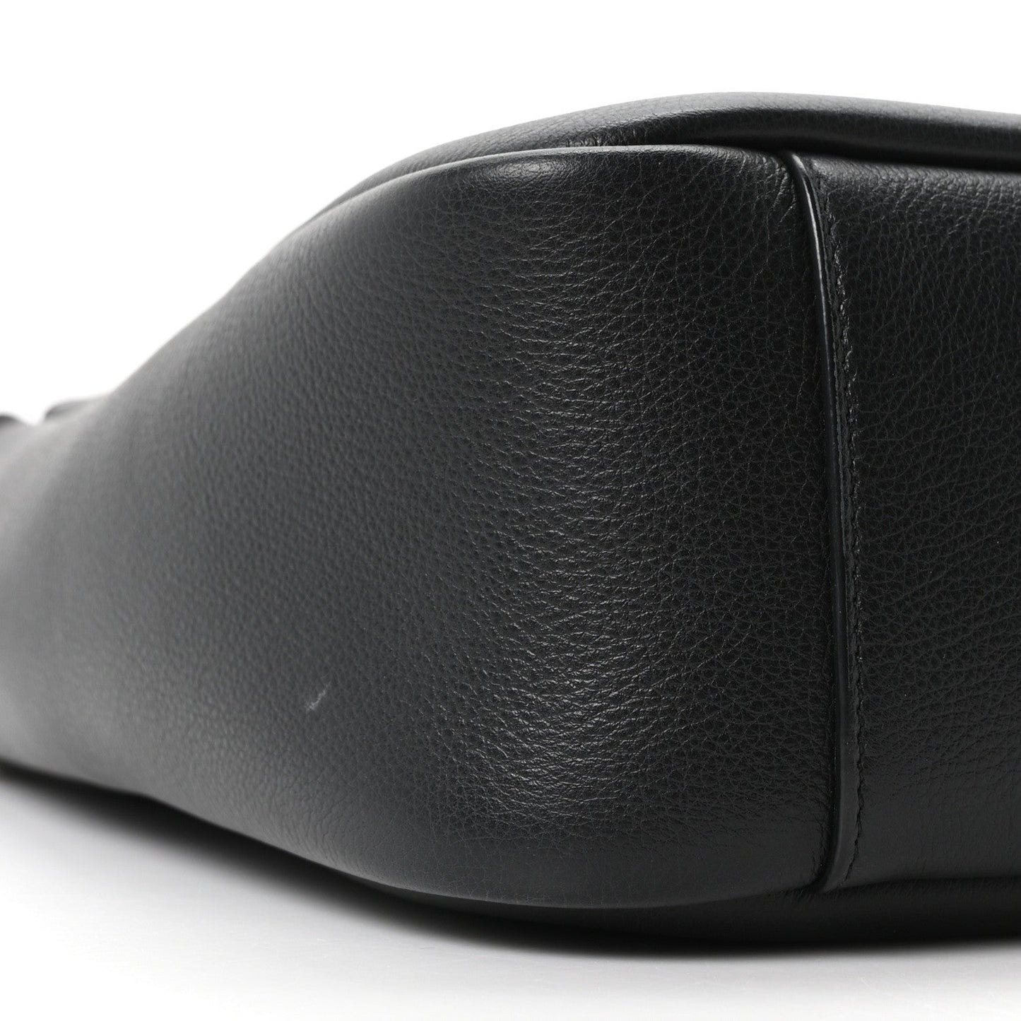 Black smooth calfskin hobo bag close-up of front panel and side seam