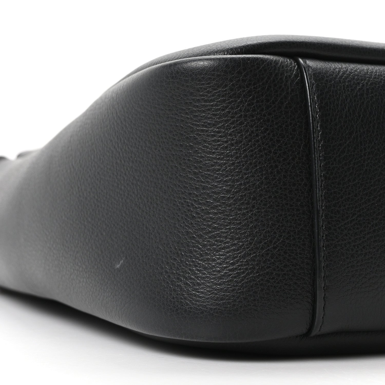 Black smooth calfskin hobo bag close-up of front panel and side seam