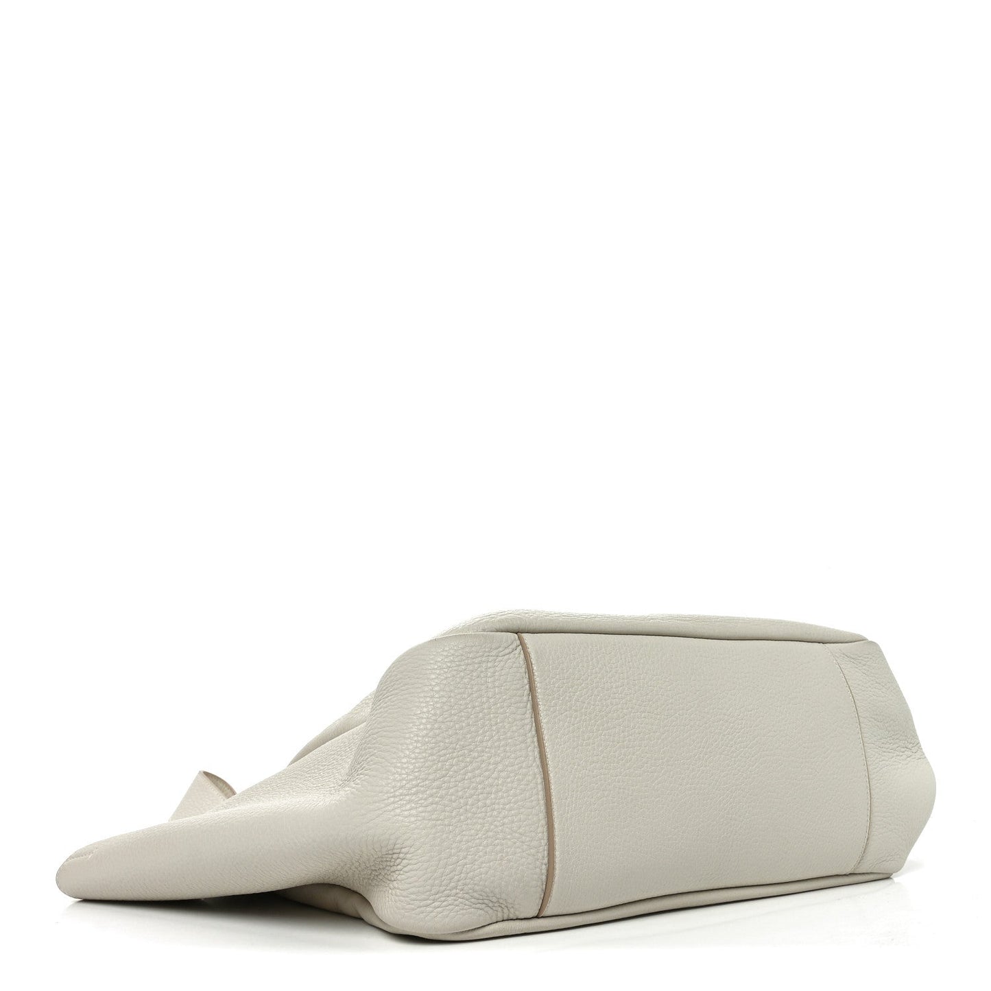 White grained leather tote bag lying down with curved bottom seam