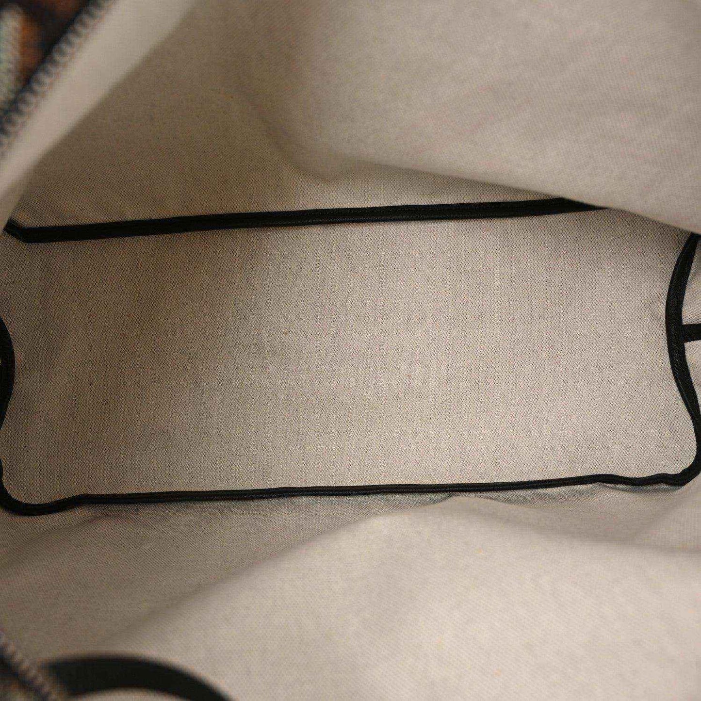 Beige interior lining with black trim of hobo shoulder bag