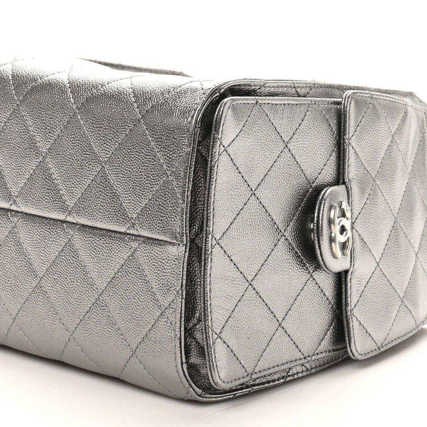 Chanel metallic quilted handbag side view with front pocket flap and turn-lock